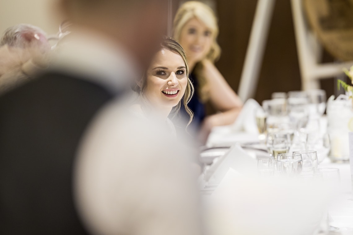 bride smiling during best men speech