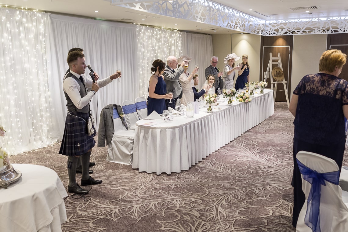 best men raise a toast at the end of their speech