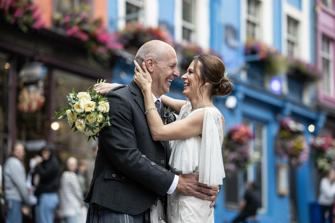 Newlyweds photographed on Victoria Street after their City Chambers wedding.