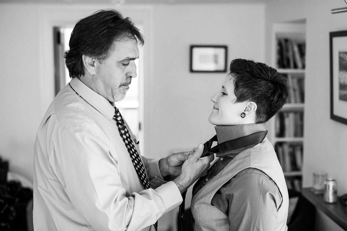 father of the bride helps daughter prepare