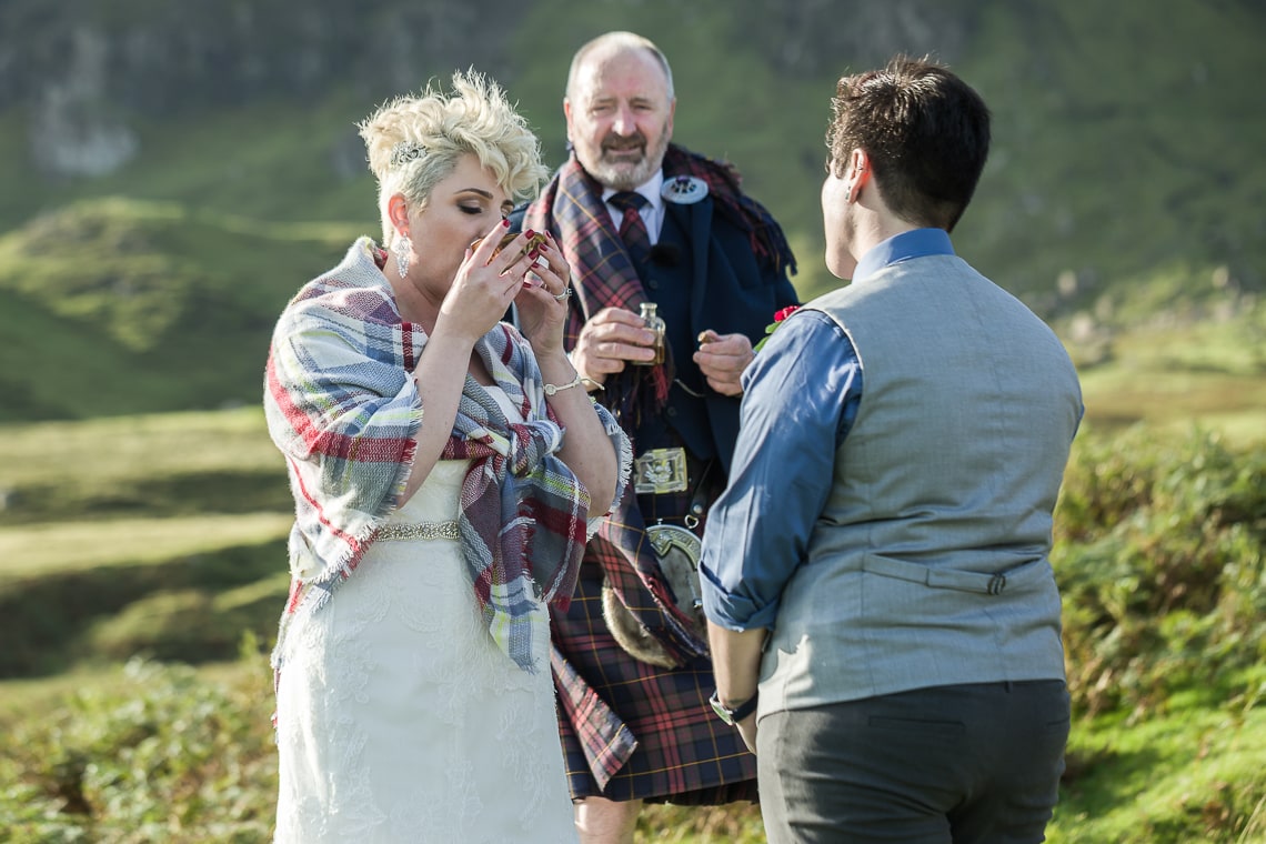 lesbian couple drink from a quaich