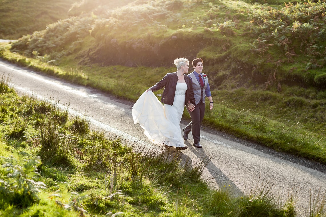 lesbian couple walking on a road Quiraing