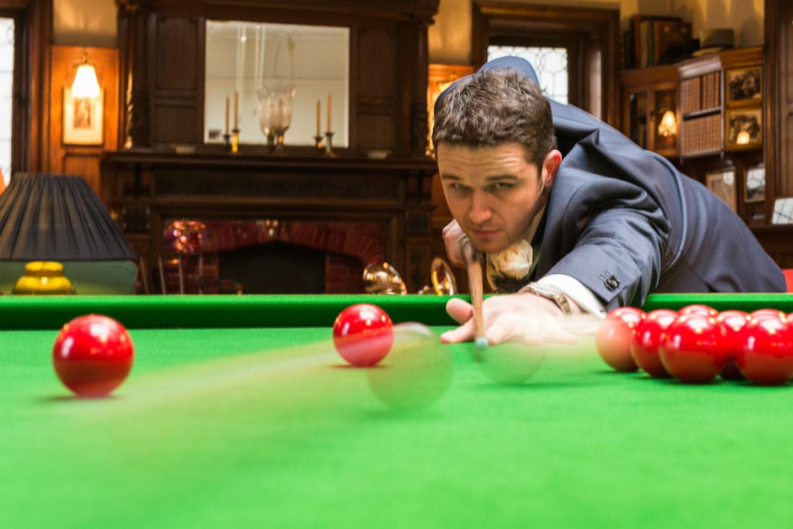 groom playing snooker in the Billiards Room