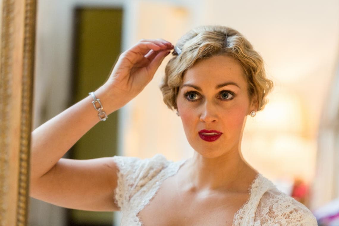 bridal preparations bride in front of a mirror in the Winter bedroom