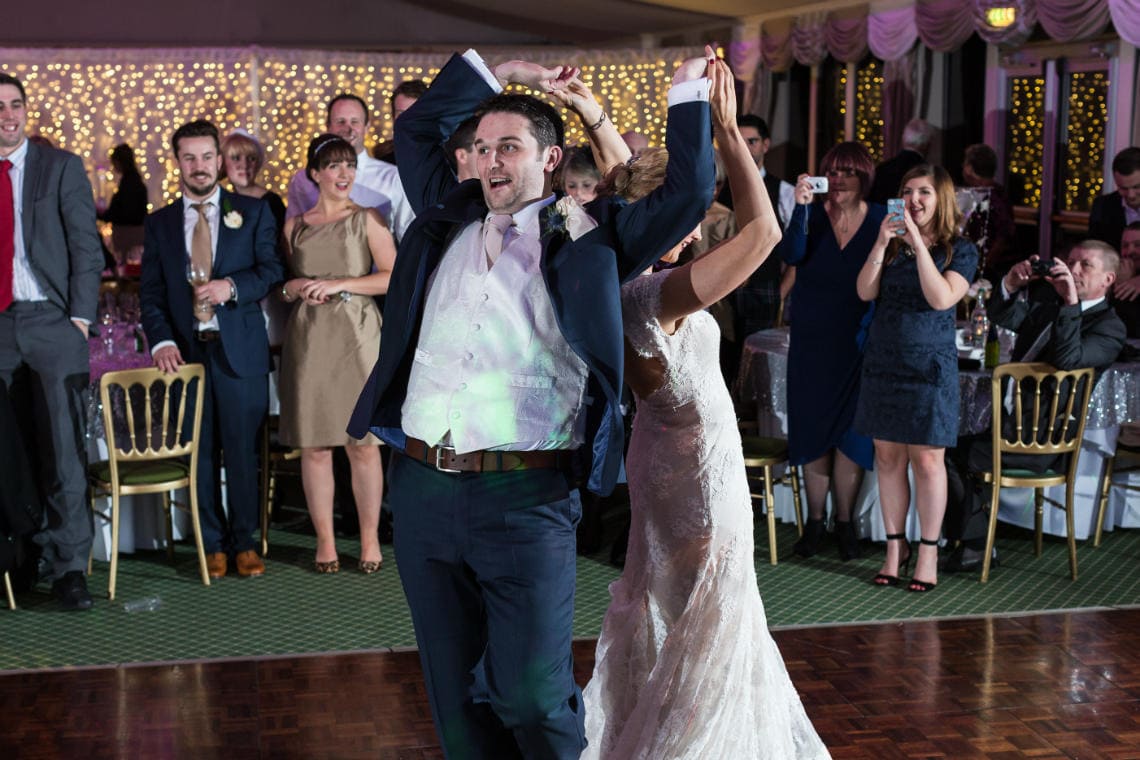 newlyweds' first dance in the Pavilion with guests watching from the side