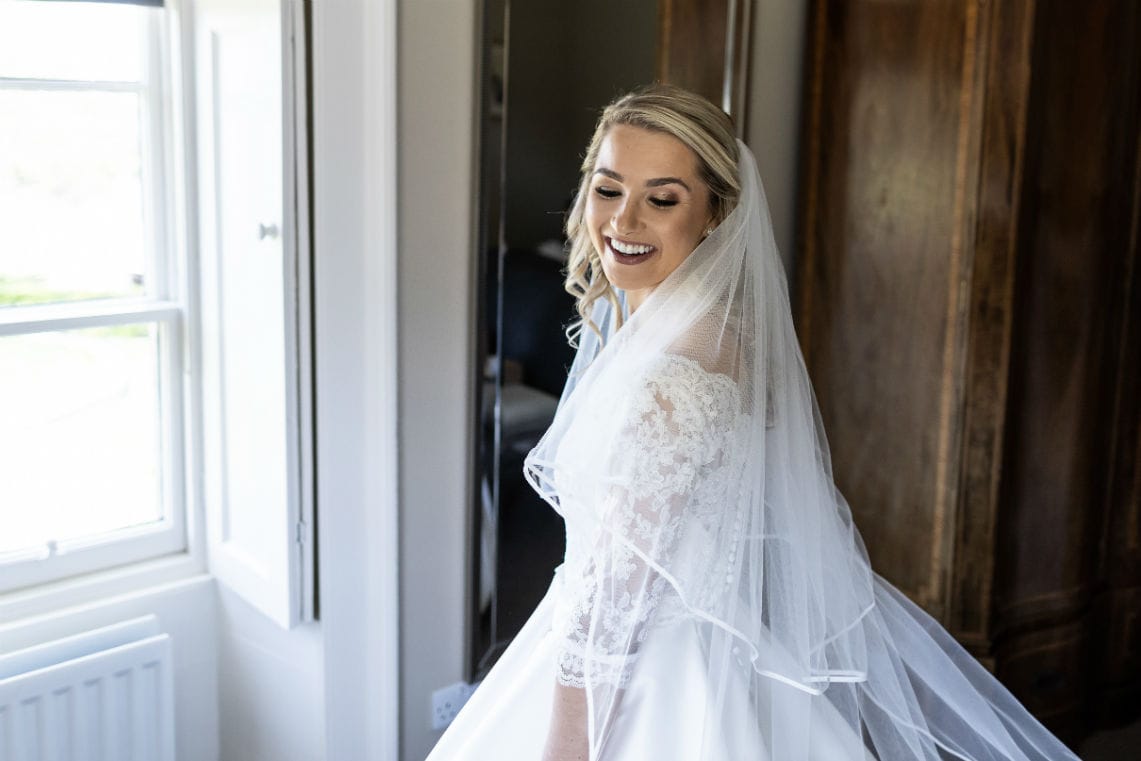 bridal pose in her dress pre-ceremony