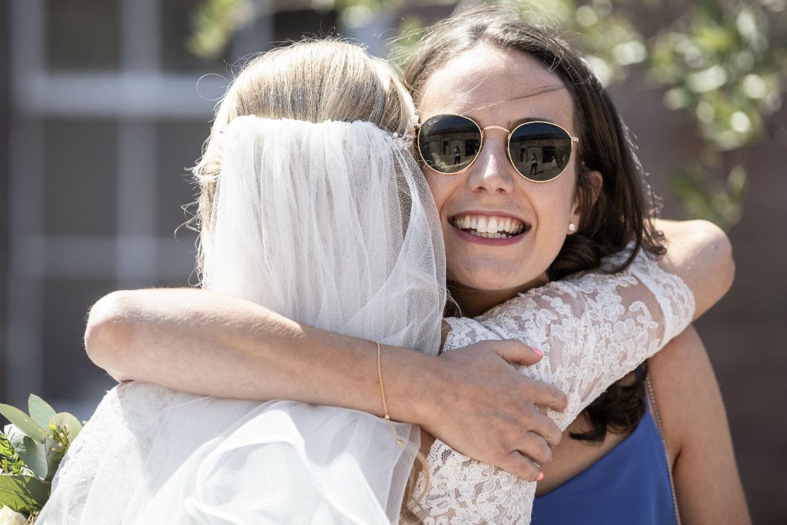 female guests hugs the bride