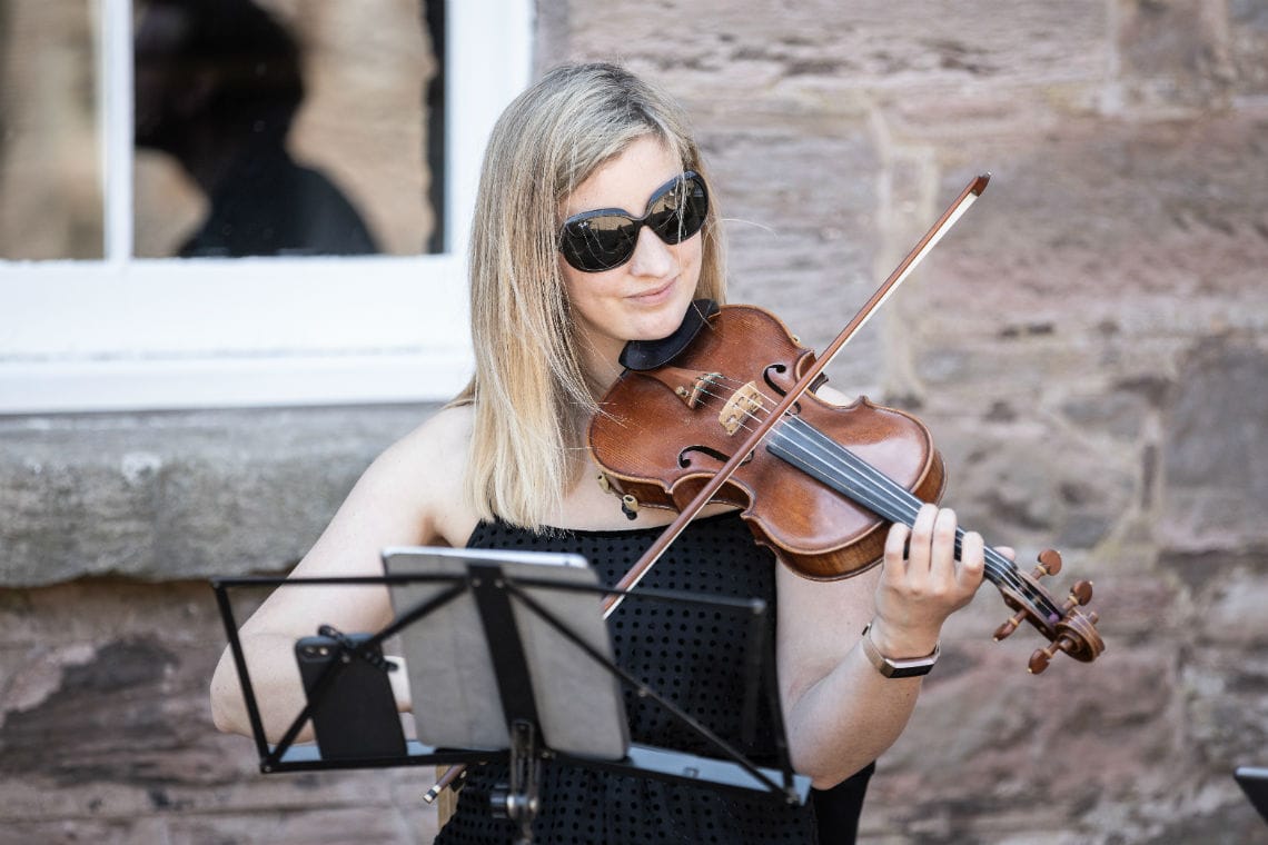 female violinist in the courtyard