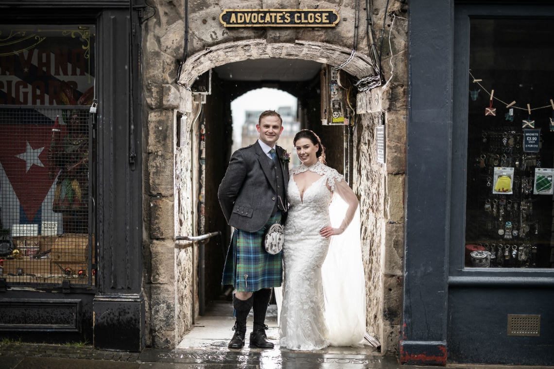 Edinburgh City Chambers elopement - newlyweds standing in the entrance to Advocate's Close