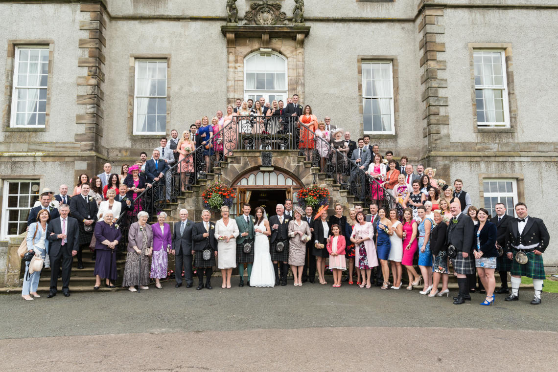 three cheers from the bride, groom and all their guests on the staircase at the rear of the Dalmahoy Hotel