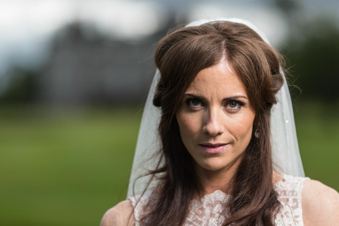 bridal portrait on the golf course with the hotel blurred in the background