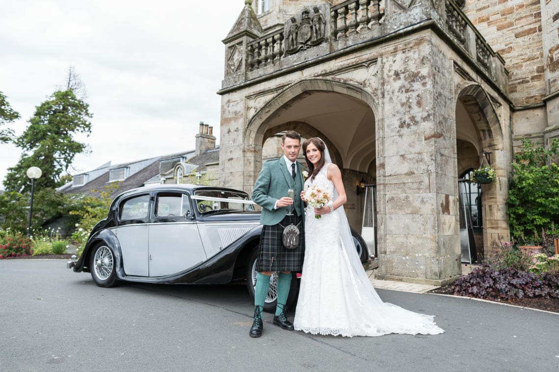 Golf course and grounds - newlyweds by their classic car - Dalmahoy Hotel wedding photography
