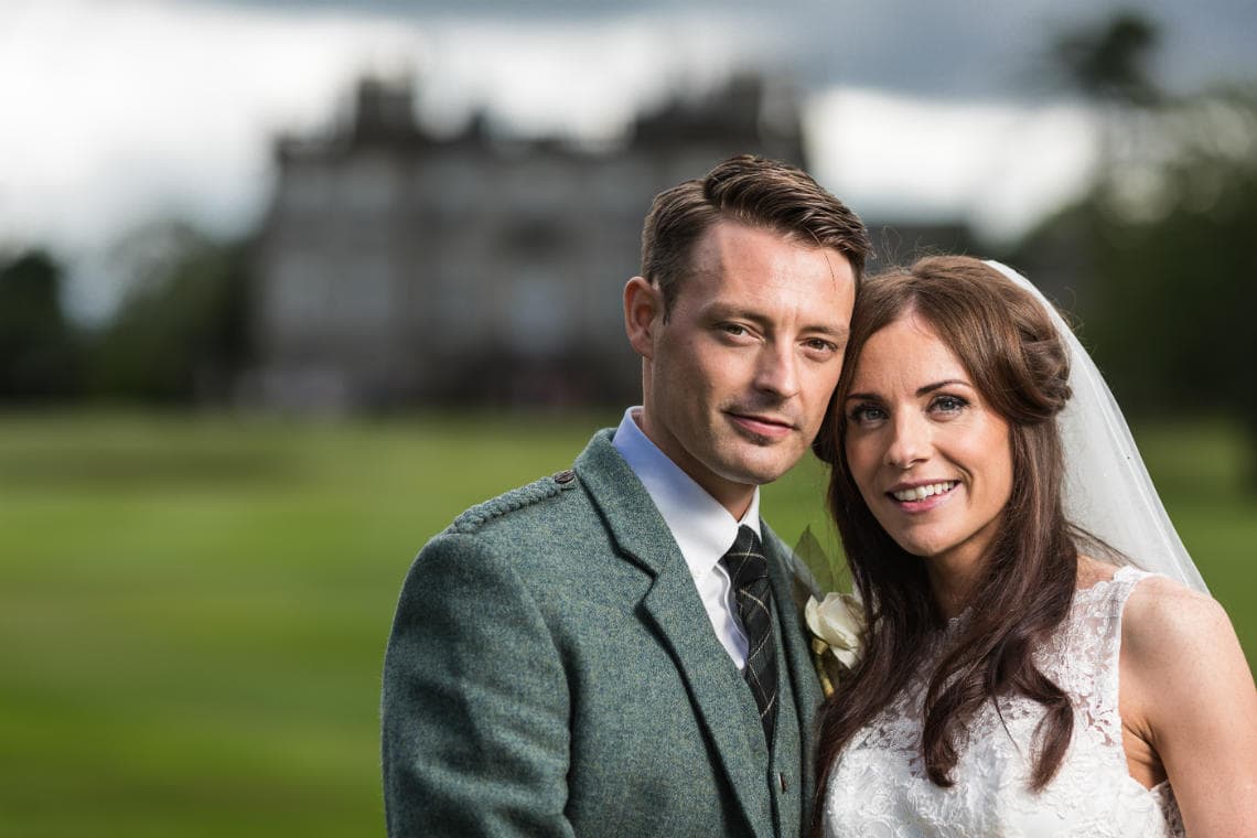 Golf course and grounds - newlyweds with hotel backdrop