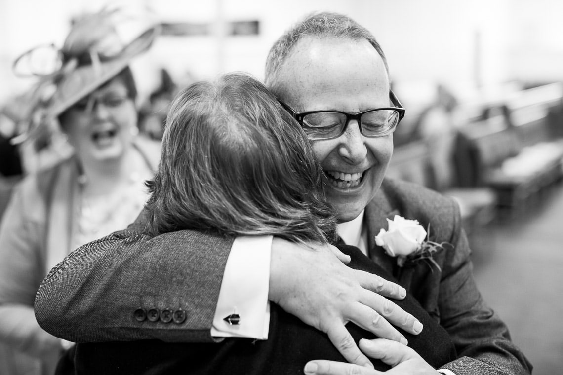father of the groom welcomes a guest
