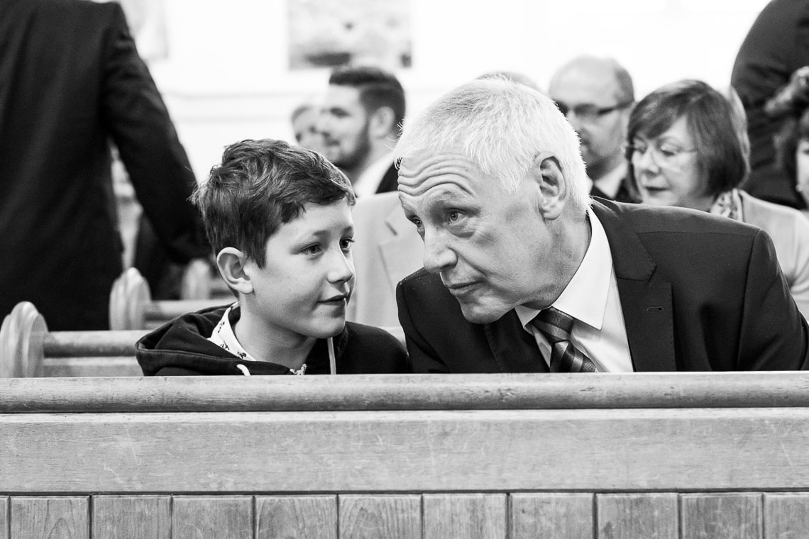 man and boy sitting on a pew in Liberton Kirk
