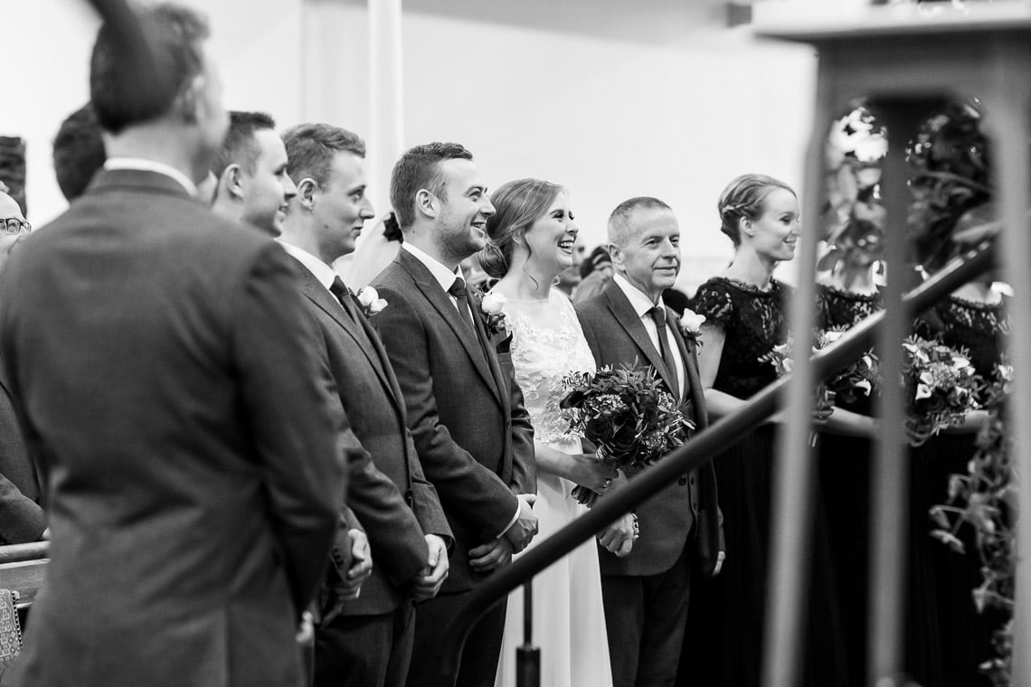 wedding party smiling during the ceremony