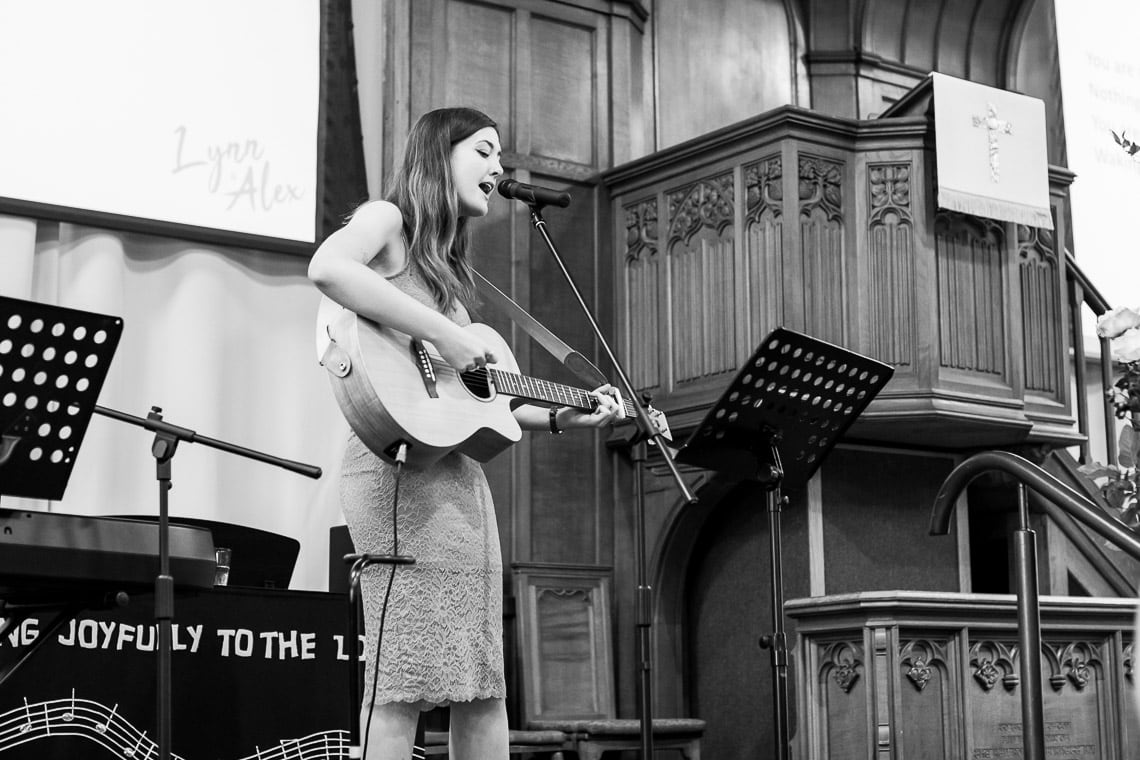 acoustic guitar player during a hymn