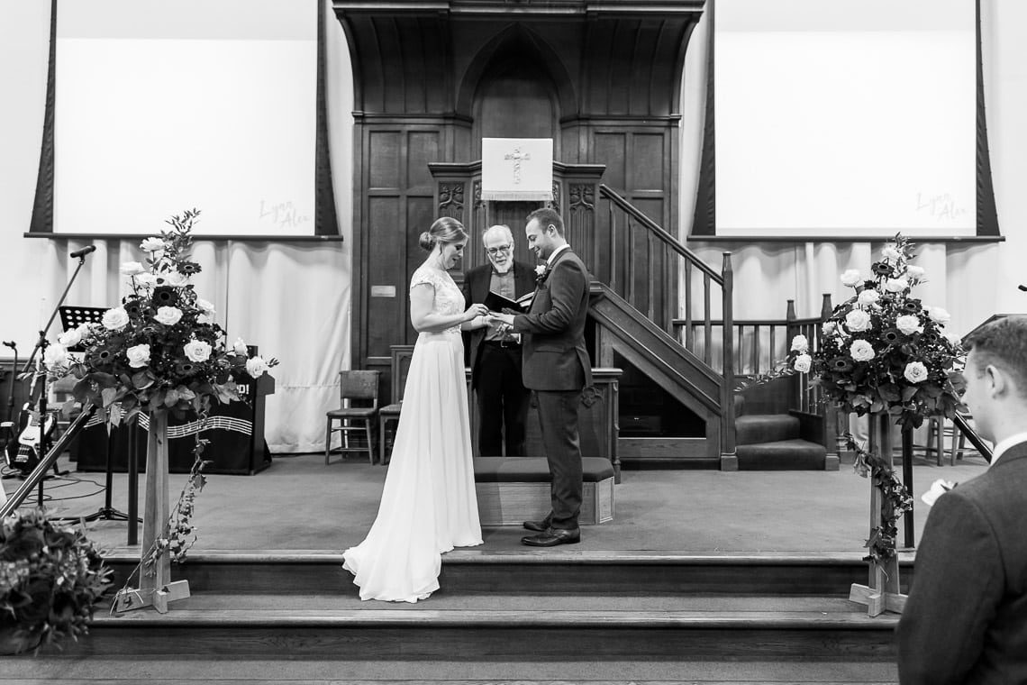 exchange of rings during ceremony at Liberton Kirk