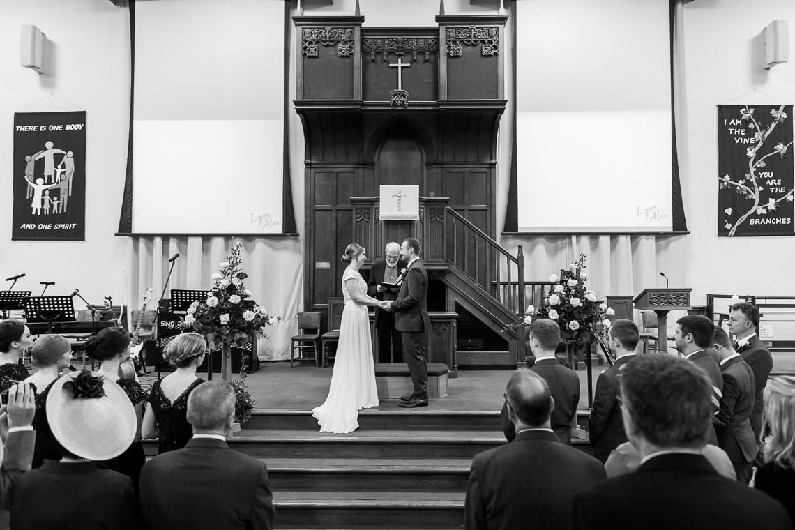 exchange of rings during ceremony at Liberton Kirk