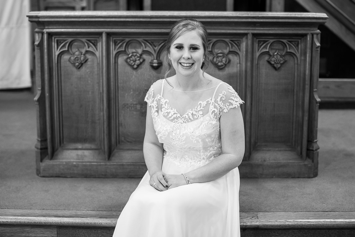 bride sitting on the altar