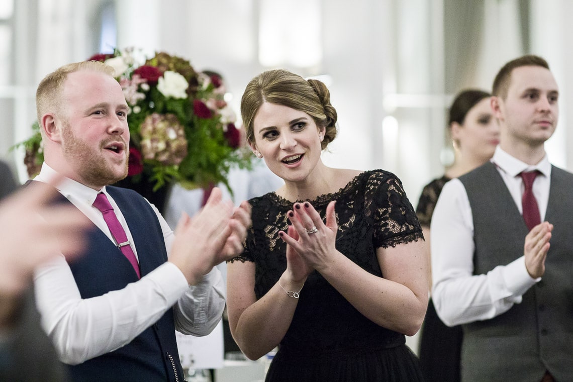 guests applaud the newlyweds as they enter the King's Hall