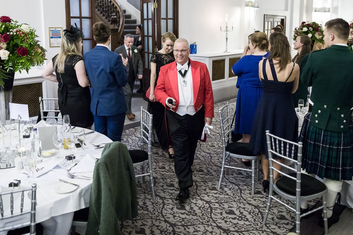 Toastmaster Maurice King leads the newlyweds as they enter the King's Hall