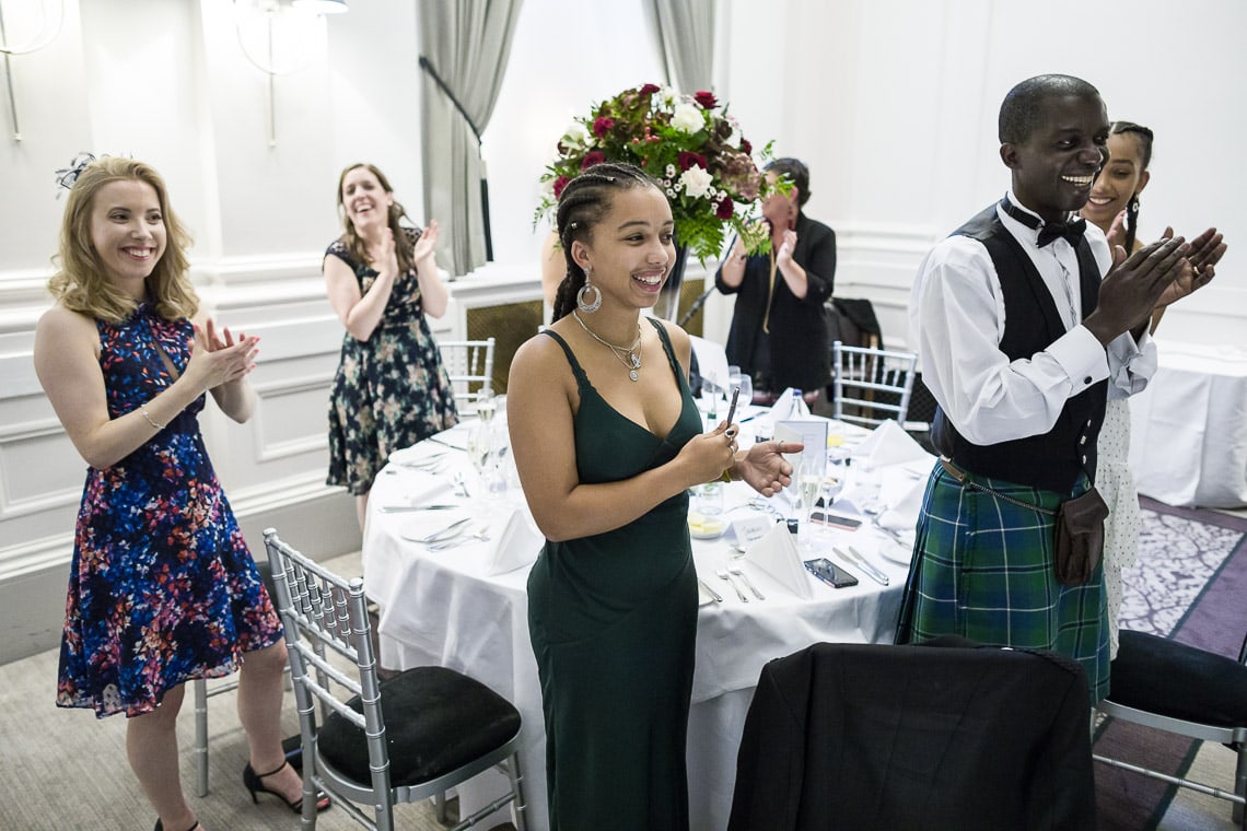 guests applaud the newlyweds as they enter the King's Hall