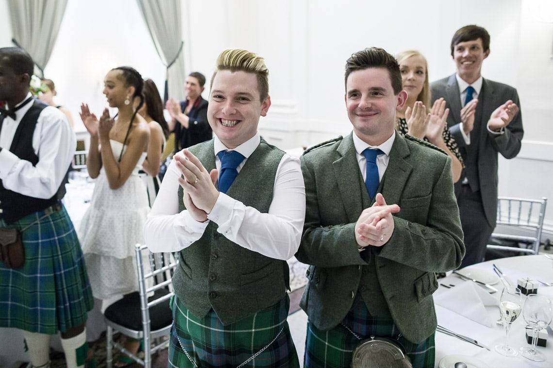 guests applaud the newlyweds as they enter the King's Hall