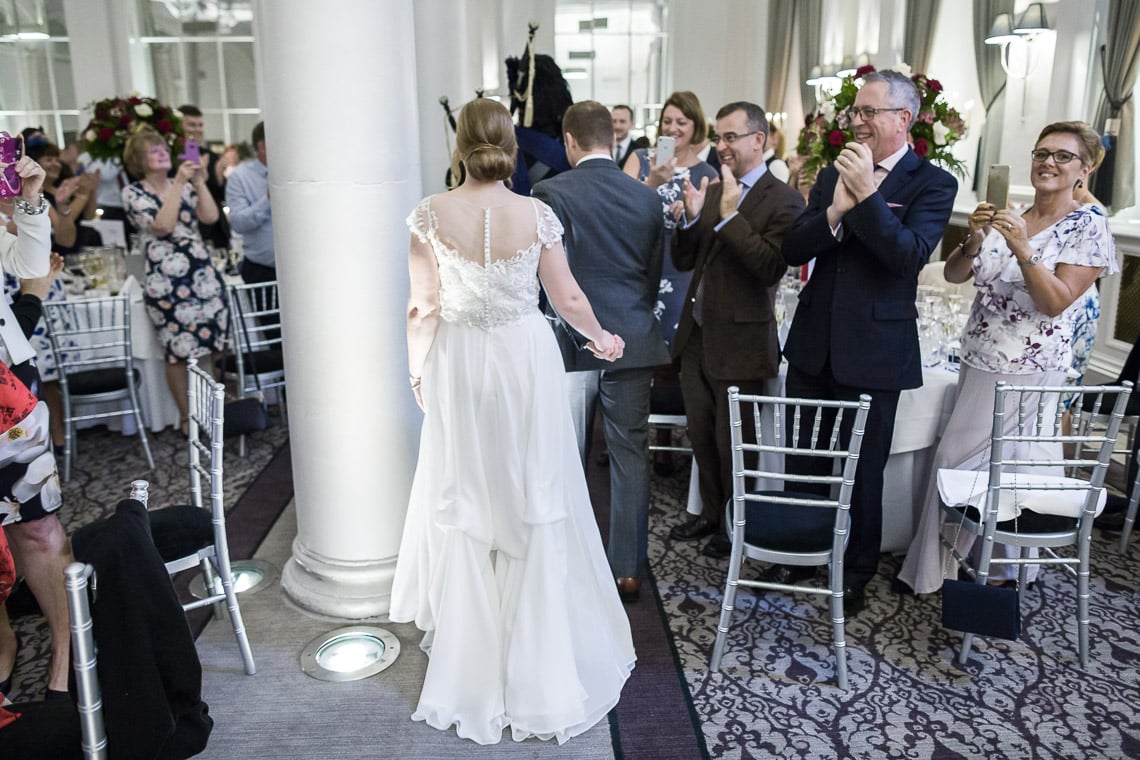 the newlyweds make their way to the top table in the King's Hall