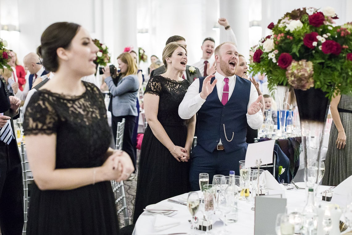 guests applaud the newlyweds as they enter the King's Hall
