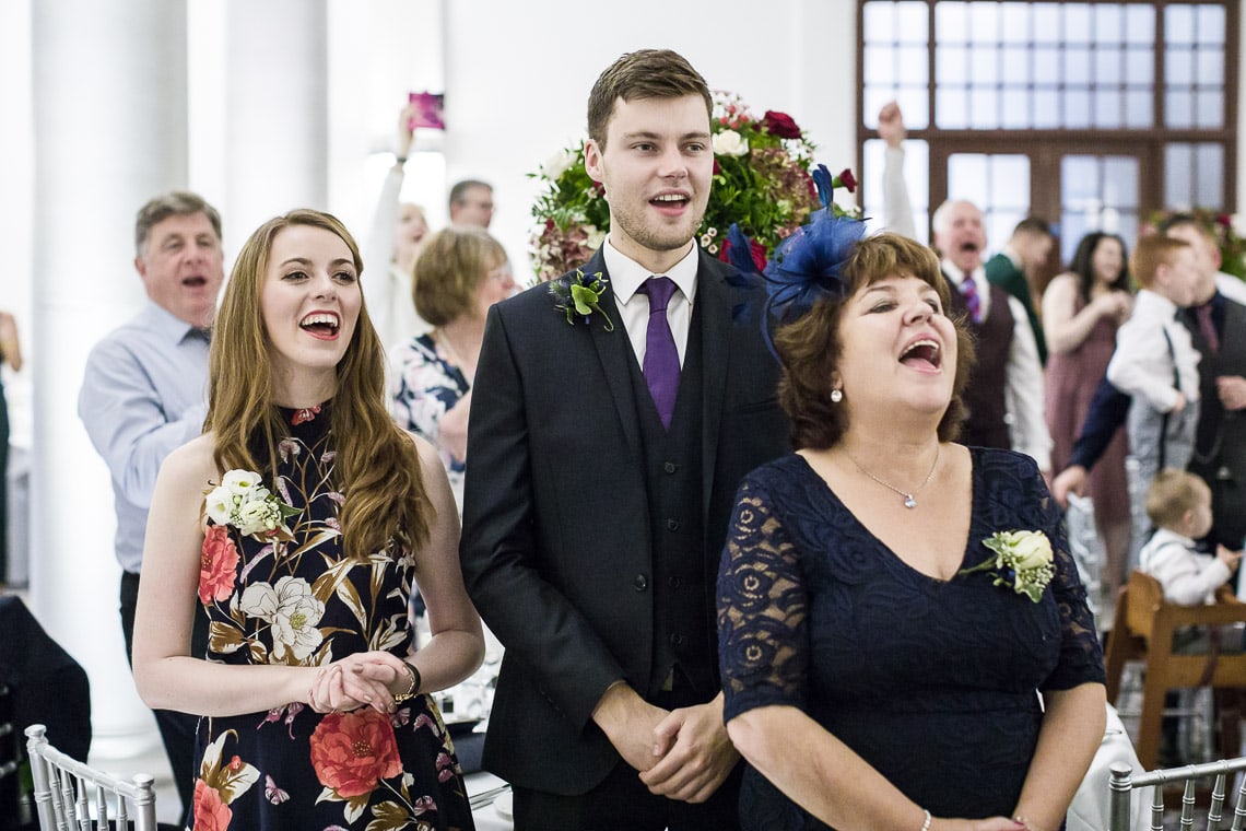 guests applaud the newlyweds as they enter the King's Hall