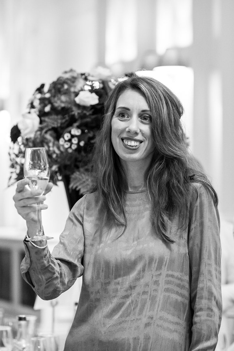 female guest raises a toast
