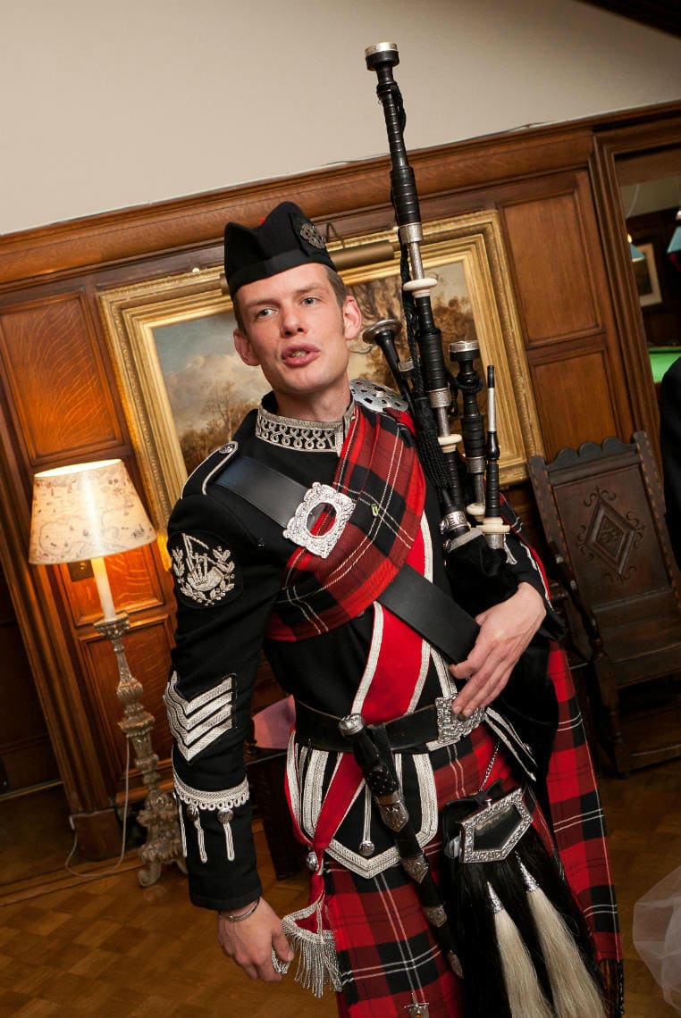 Main Hall piper announces dinner
