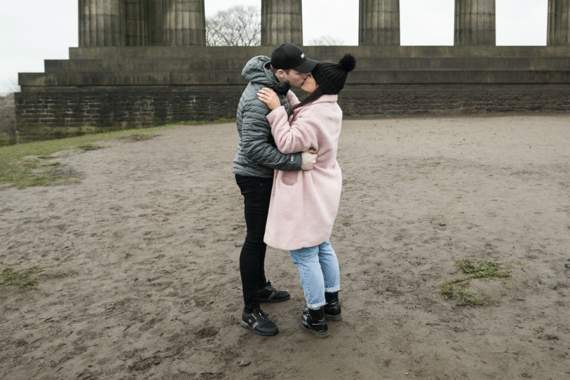 couple embrace after she agrees to marry him