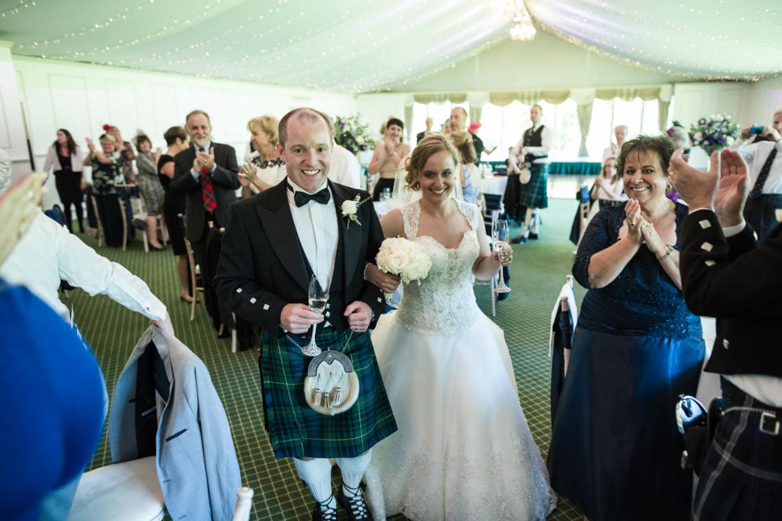 Pavilion newlyweds are cheered to the top table