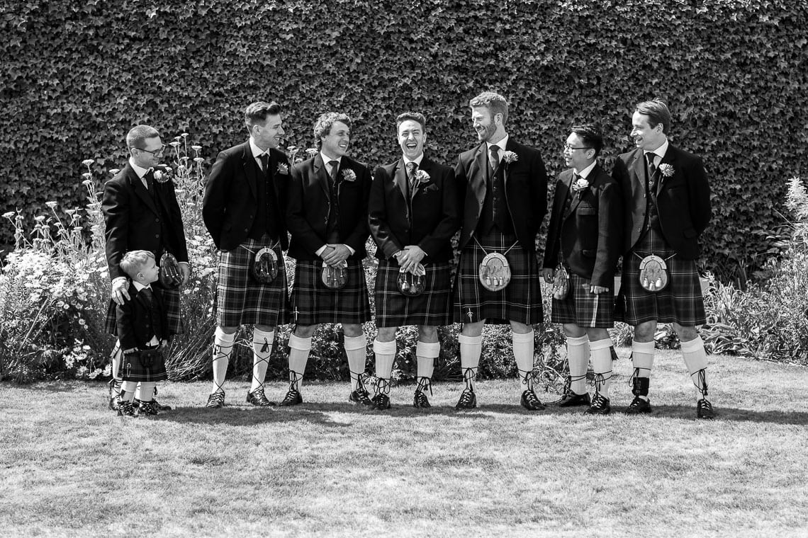 groom and groomsmen laughing outside in the Quadrant