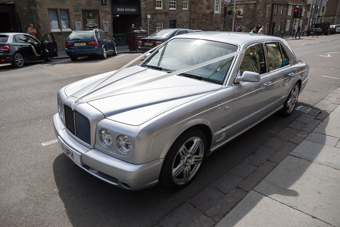 bride arrives in a Bentley at St Salvator's Chapel
