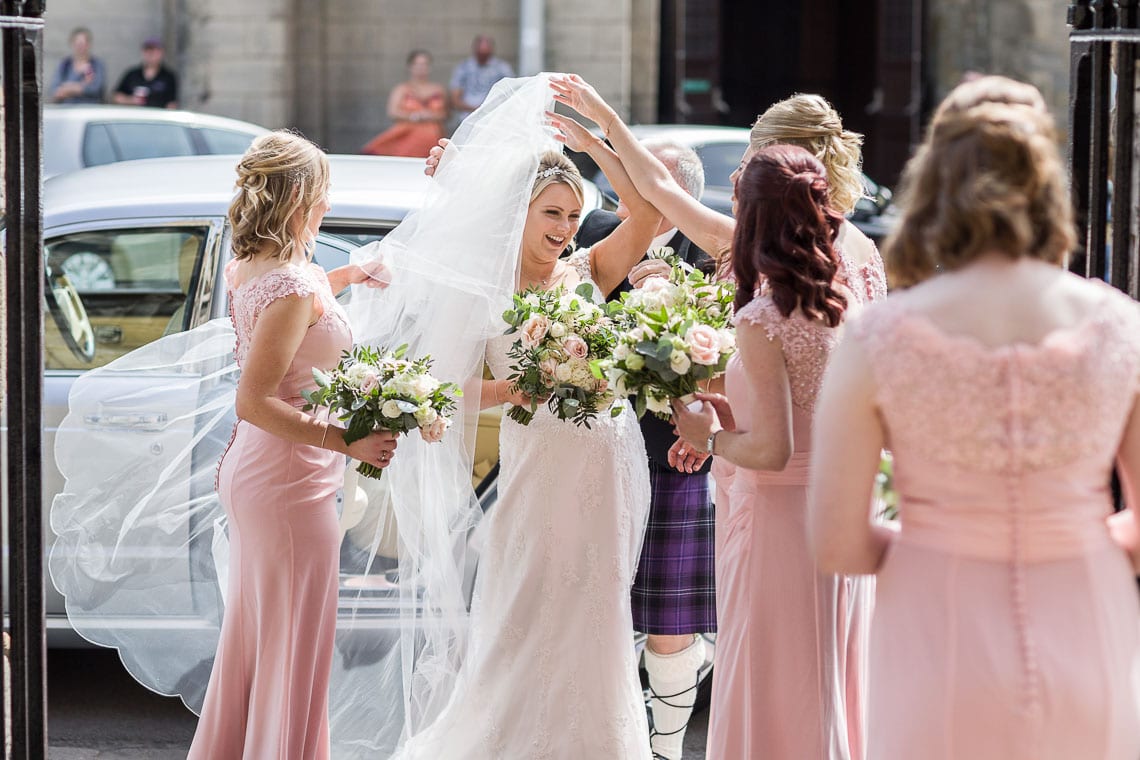 bride adjusts veil outside