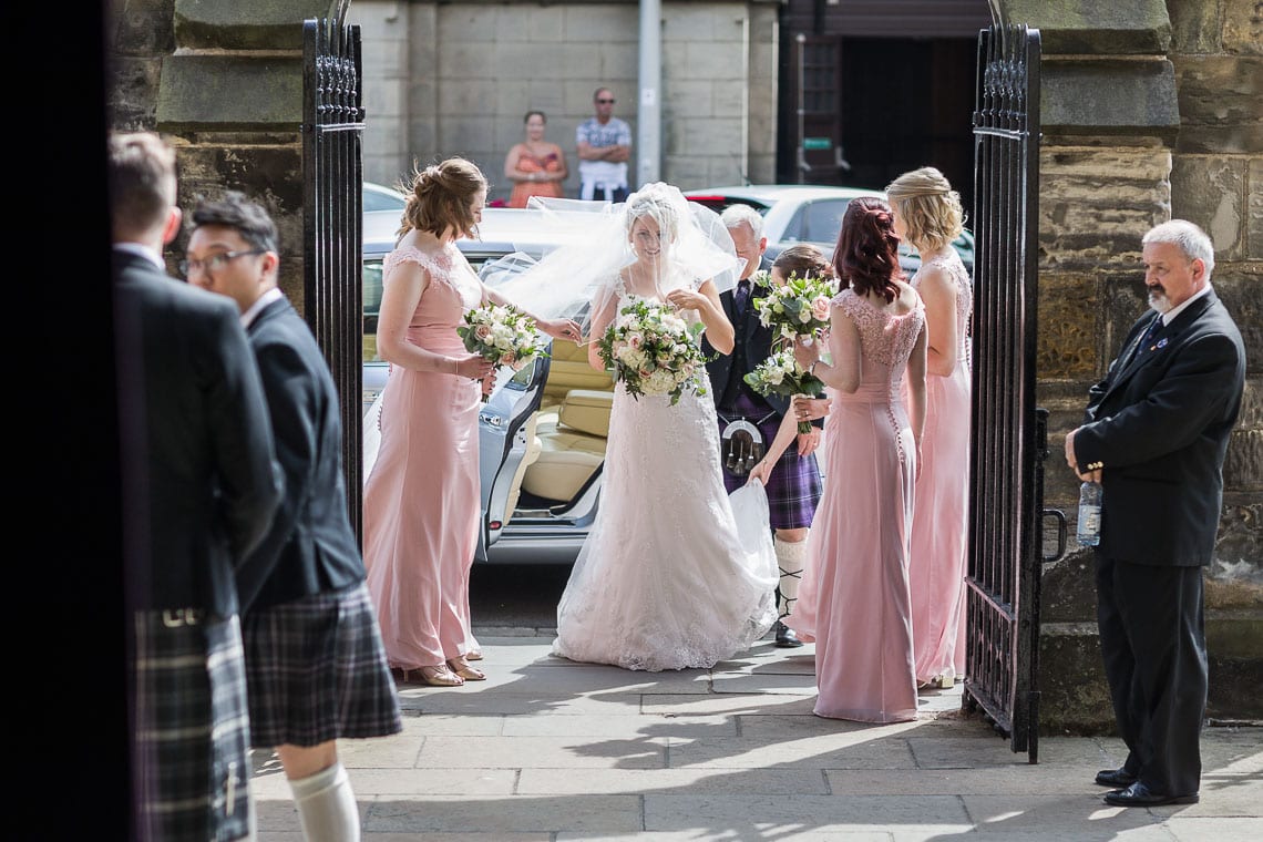 bride and bridesmaids prepare to walk down the aisle