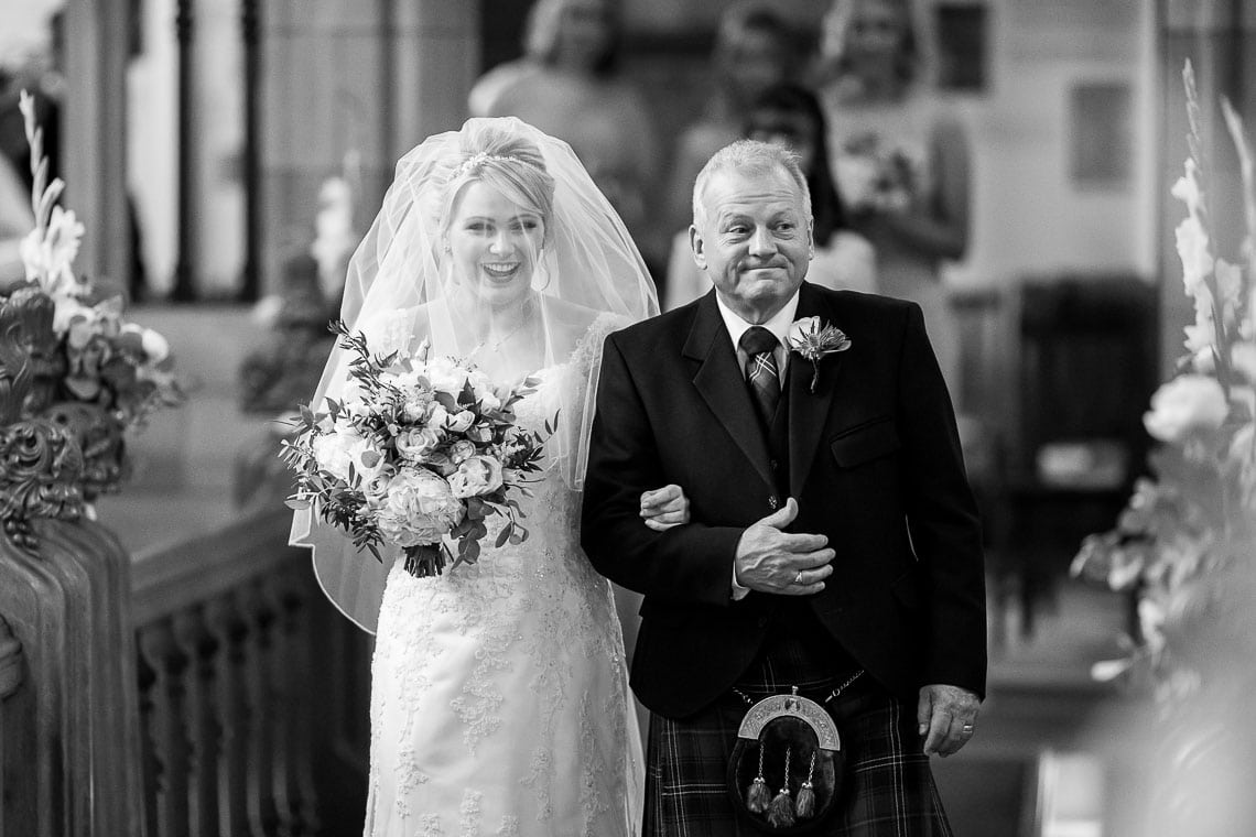 bride escorted by her father up the aisle