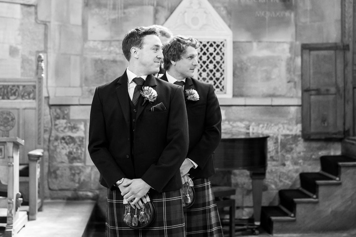 groom watches bride escorted by her father up the aisle