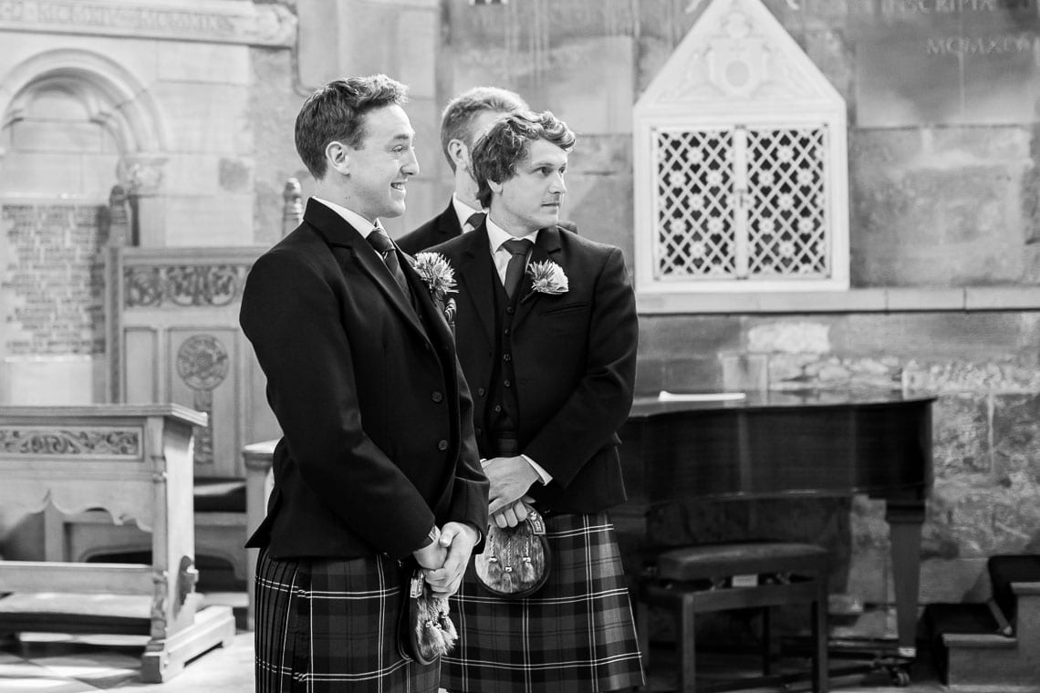 groom watches bride escorted by her father up the aisle