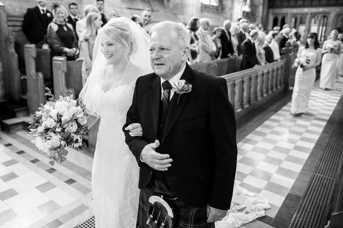 bride escorted by her father up the aisle