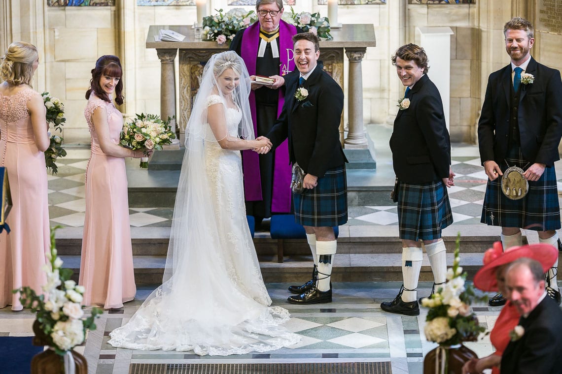 bride and groom delighted to see the page boy bringing the wedding rings