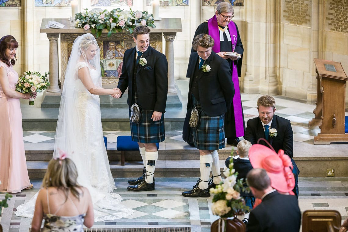 bride and groom delighted to see the page boy bringing the wedding rings