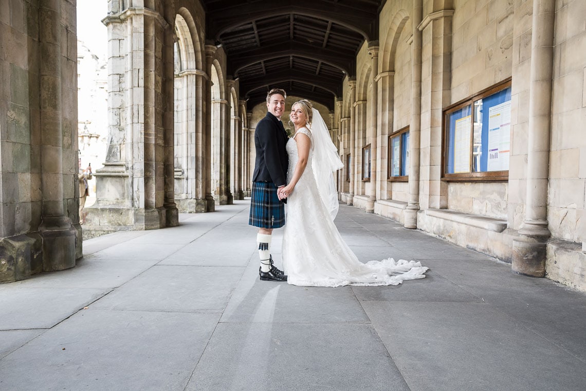 newlywed photo standing under the arches at St Salvator's Chapel