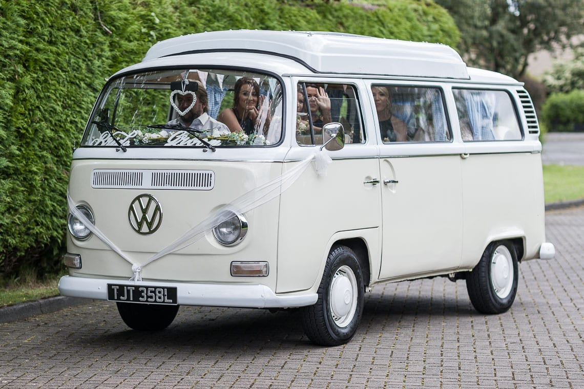 bridal party arrive in a classic VW camper van