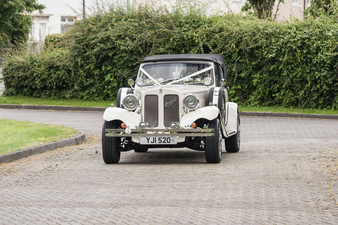 bride arrives in a Beauford car