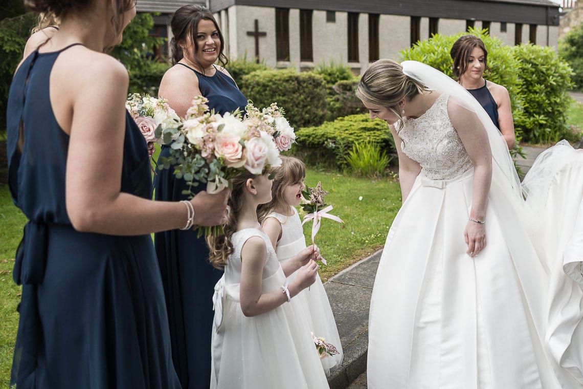 bride greets flower girls