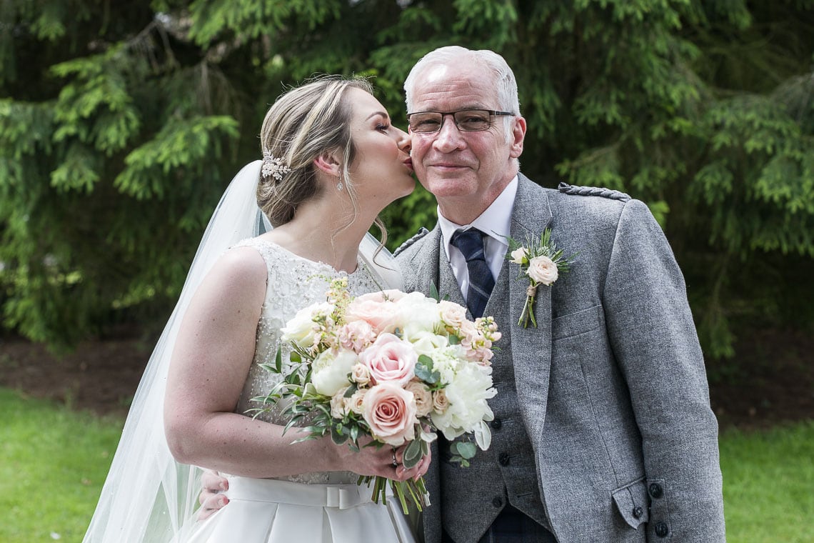 bride kisses her father